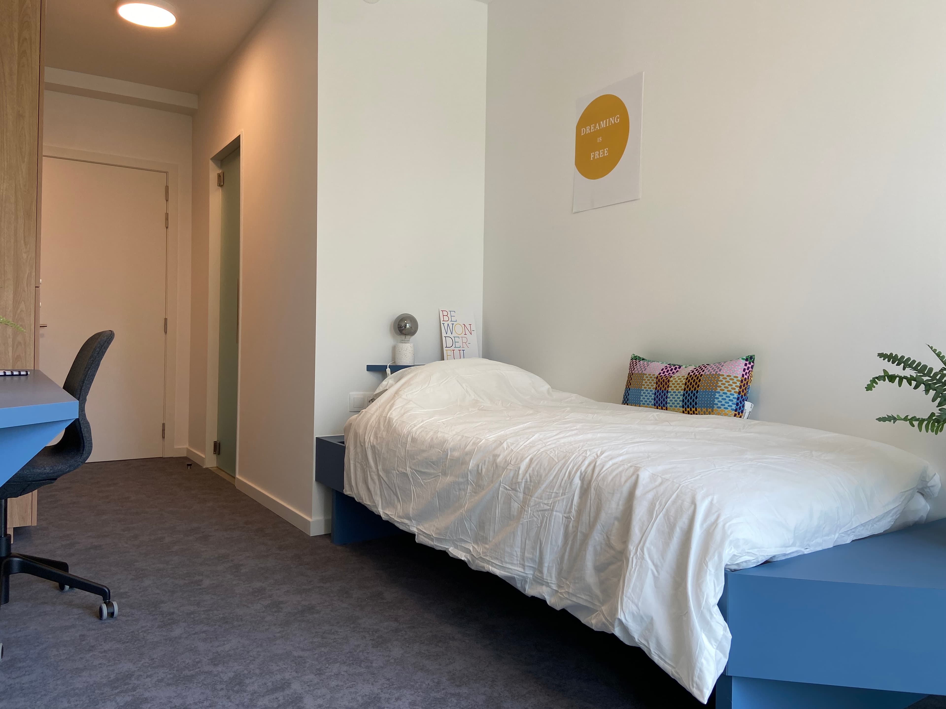 Bed and window in a CityCampus co-housing room
